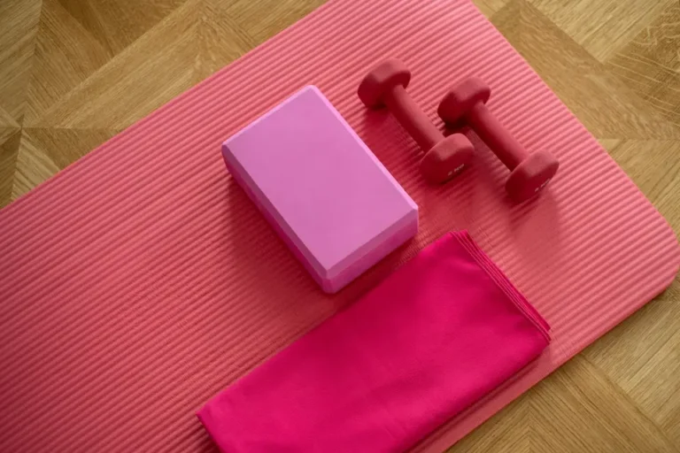 Pink colored home gym gear on the floor